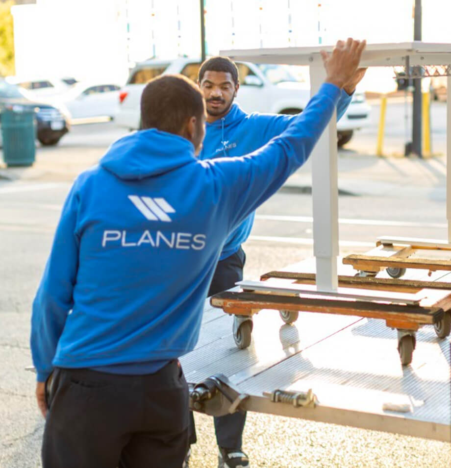 Planes moving and storage loading up a desk, white glove delivery
