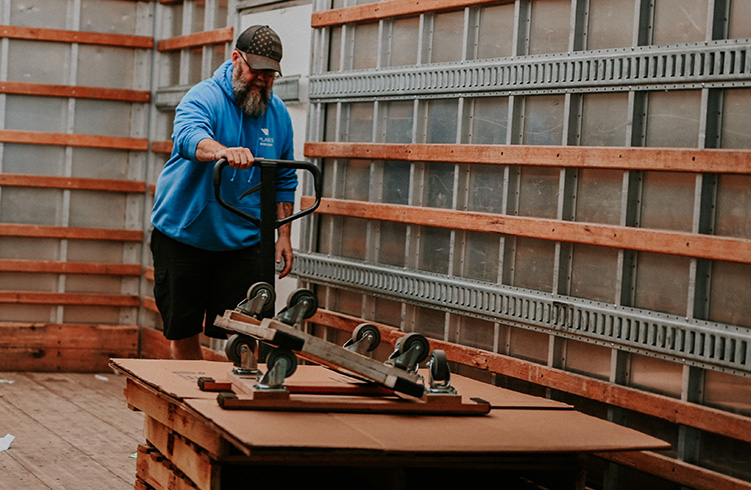 Planes employee removing pallets from truck
