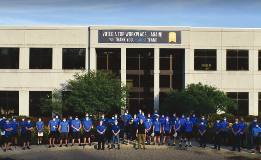 Cincinnati office exterior with planes staff in masks standing out front